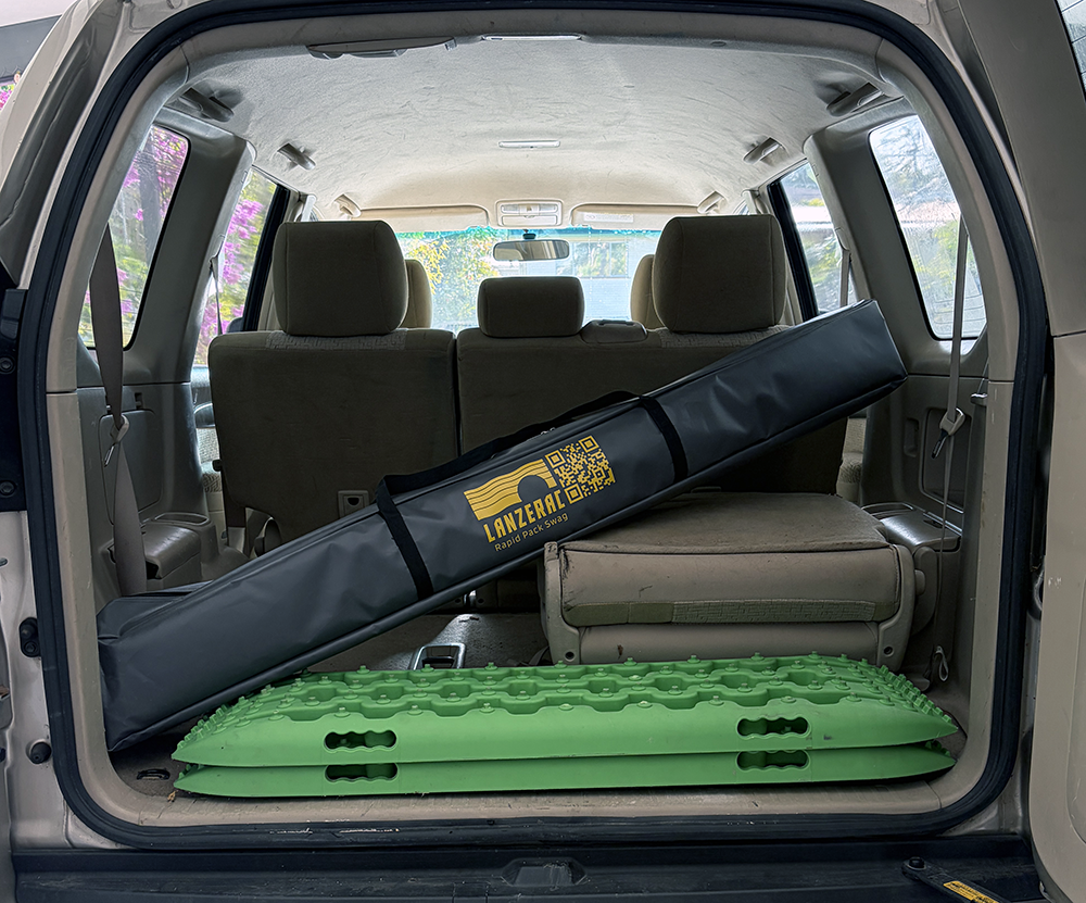 Pop-up style swag tent. In back of car