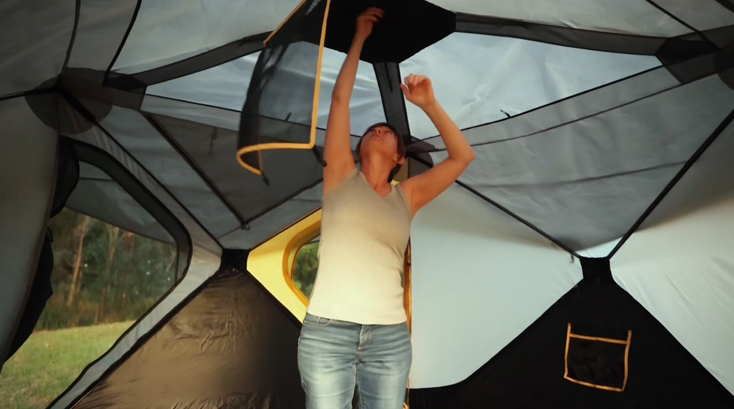 Person standing up inside tent